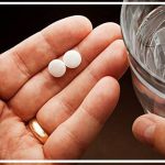 getty_rf_photo_of_hand_with_pills_and_water